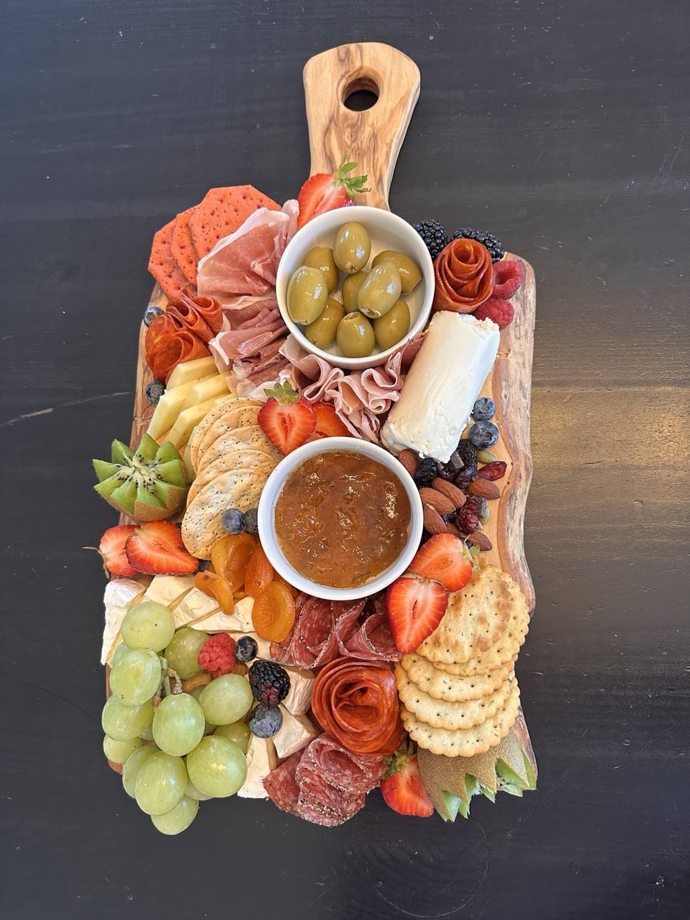 San Antonio charcuterie board with cured meats, cheeses, fruit, olives and crackers