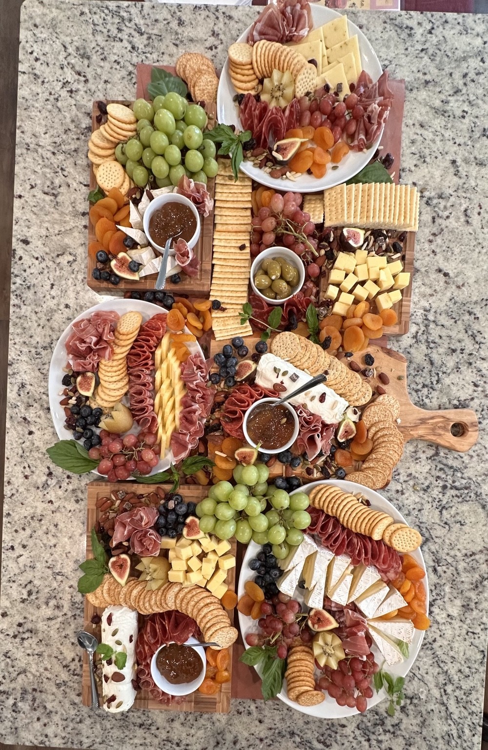 Large charcuterie and grazing spread with meats, cheeses, crackers and fruit